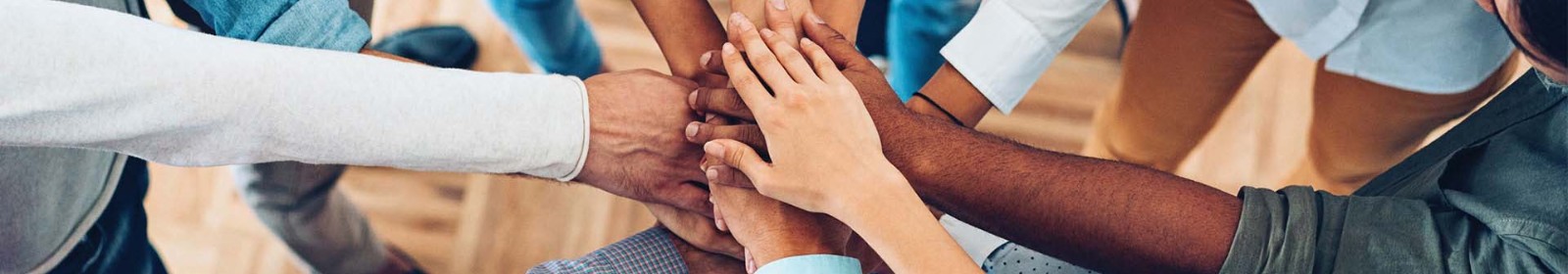 a group of hands piled in the center