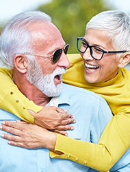 an elderly couple smiling