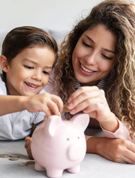 a mother and her child putting money in a piggy bank