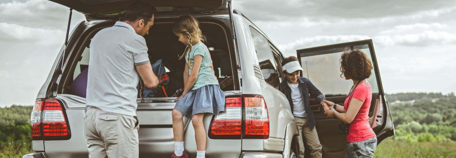 a family unpacking their vehicle